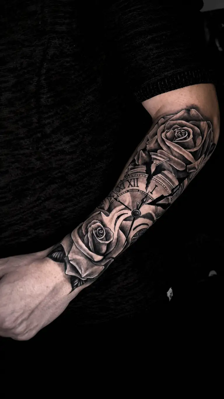 Black and grey realism sleeve tattoo with rose and clock details.