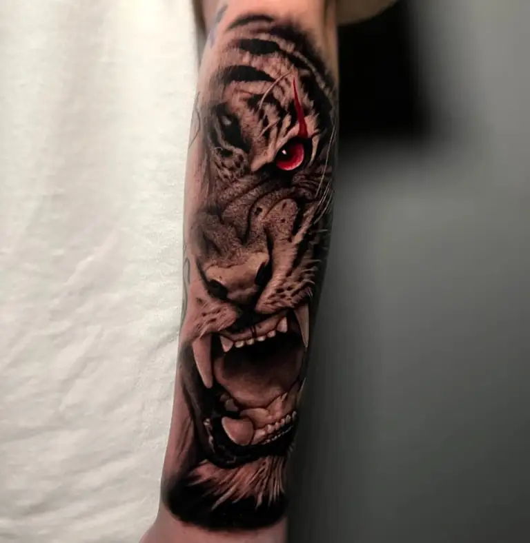 Black grey tiger with red eye forearm tattoo at Eleven Tattoo Gallery Istanbul.
